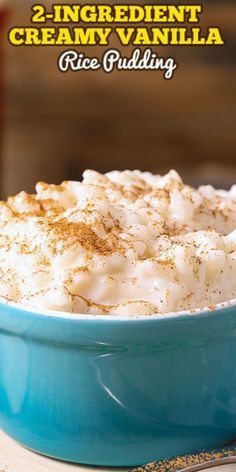 a blue bowl filled with rice pudding on top of a table