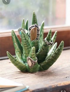 a small green plant sitting on top of a window sill next to a window