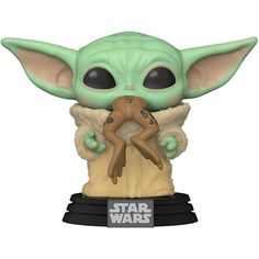 a star wars baby yoda holding a toy