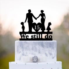 a cake topper with the words we still do and family silhouettes on it