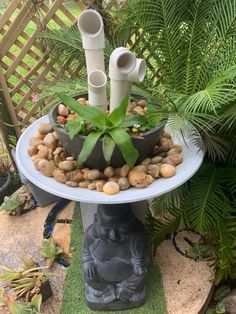 a planter with rocks and plants in it