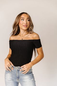 The off-the-shoulder design with short sleeves adds a touch of sophistication, making it suitable for various occasions. Pair it with skirts, shorts, or jeans, and effortlessly transition from day to night with ease. Off The Shoulder Bodysuit, Body Suit With Shorts, Layer Dress, Short Sleeve Bodysuit, Fitted Silhouette, Black Bodysuit, Dress Romper, Feel Confident, Black Shorts