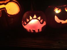 three pumpkins with faces carved into them