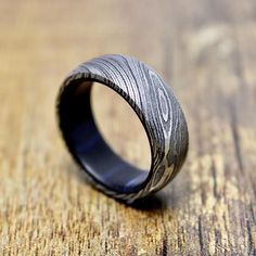 a wooden ring sitting on top of a wooden table