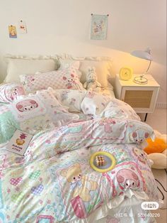 a bed with many pillows on top of it and a stuffed animal in the middle