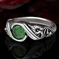 a ring with a green stone in the center