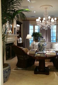 a living room filled with furniture and a chandelier