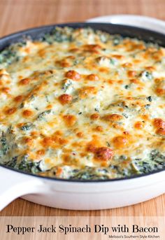 a casserole dish with cheese and spinach