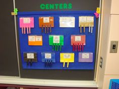 a bulletin board with lots of different colored paper clips on it and the words centers written in green