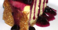 a piece of cheesecake with blueberries and sauce