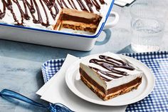 a piece of cake sitting on top of a white plate next to a blue and white checkered napkin