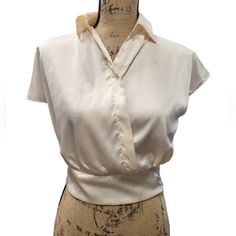 Pearl In Color This Small Faux Silk Blouse Is Elegant And Stylish. 97% Polyester/3% Spandex With A Zippered Waist It Compliments All The Right Areas. Stylish Enough For The Office, Yet Elegant Enough For A Night Out On The Town. G Solid Collared Tops For Night Out, Elegant Cropped Cream Top, Elegant Cream Cropped Tops, Stretch Collared Top For Night Out, Chic Cream Cropped Blouse, Chic Cream Tops For Night Out, Chic Cream Top For Night Out, Chic Cropped Top For Office, Elegant Stretch Cropped Blouse