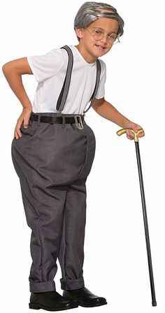 a young boy dressed in an old fashioned outfit and suspenders, holding a cane