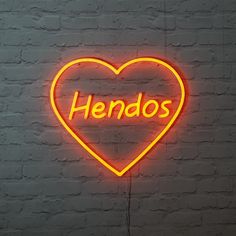 a neon sign with the word hendos written in it's heart on a brick wall