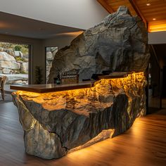 a large rock sitting on top of a hard wood floor next to a bar in a living room