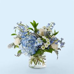 a vase filled with blue and white flowers