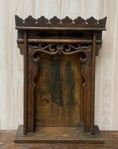 an old wooden shelf with a painting on it