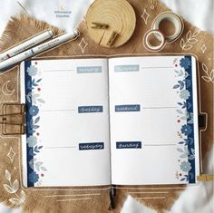 an open planner book sitting on top of a table