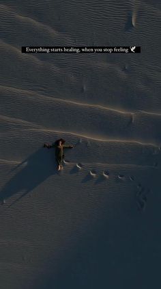 a person standing in the snow with their arms spread out and there is a quote above them