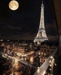 the eiffel tower is lit up at night