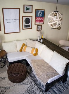 a living room filled with furniture and pictures on the wall above it's couch