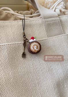 a crocheted keychain with a small piece of food on it