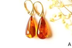 The earrings of Baltic amber in rich honey colour will not betray your expectations. It is one of the most popular colours of Baltic amber. Executed in the shape of a drop, they will perfectly match to any outfit. These lightweight, elegant, sophistically sparkling earrings with a spangle inside are an irresistible piece of jewellery that you will love wearing every day. It is a genuine, natural and unique piece of jewellery created by nature, so you will feel special on every occasion. Delight yourself or your loved one with a little miracle from nature.  EARRINGS A Earrings length with clasp: 4.3 cm. / 1.69 in Weight: 3.9  g. / 0.13 oz Color: cognac Natural Baltic amber 925 sterling silver gold plated EARRINGS B Earrings length with clasp: 3.9 cm. / 1.53 in Weight: 3.8 g. / 0.13 oz Color Amber Teardrop Earrings Gift, Amber Teardrop Earrings As A Gift, Amber Teardrop Drop Earrings For Gift, Elegant Brown Teardrop Earrings For Gift, Baltic Amber Teardrop Earrings For Gift, Baltic Amber Teardrop Earrings As Gift, Elegant Amber Teardrop Earrings, Amber Teardrop Baltic Amber Earrings, Teardrop Baltic Amber Earrings In Amber