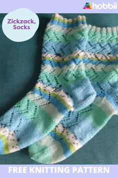 two knitted socks sitting next to each other on top of a green surface with the words, free knitting pattern