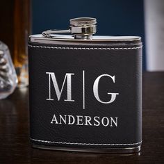 This flask, when used by a gentleman of class and distinction, will most certainly be the envy of anyone who observes. Made from premium stainless steel nestled in soft black imitation leather, these engraved hip flasks are laser engraved with the selected design. The lettering really shines in a metallic silver that truly celebrates the proud owner. The hinged, tight-sealing cap on this personalized hip flask keeps your favorite whiskey fresh and protected in any pocket or briefcase. Our monogr Personalised Hip Flask, Home Wet Bar, Liquor Flask, Wedding Gifts For Men, Engraved Flasks, Flask Set, Leather Flask, Flask Gift, Wedding Gifts For Groomsmen