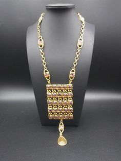 ON SALE Very nice goldette style statement necklace in good vintage condition, measures 23 in long and the pendant portion measures 6 in Long by 2 and 1/4 inches wide. Very nice addition to any jewelry collection or wardrobe. Vintage Gold Metal Rhinestone Necklace, Vintage Gold Jeweled Rhinestone Necklace, Vintage Gold Rhinestone Necklace, Gold Bohemian Necklace For Evening, Gold Vintage Rhinestone Necklace, Gold Necklace With Rectangular Pendant For Party, Bohemian Jeweled Gold Necklace, Moonglow Necklace, Desert Hot Springs