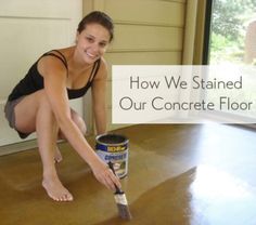 a woman kneeling on the floor with a paint can