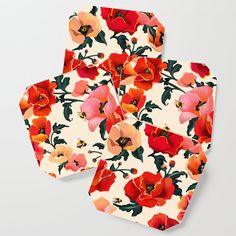 four coasters with red and orange flowers on them