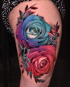 a woman's thigh with colorful roses and leaves on the side, tattoo style