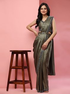 This stunning saree comes pre-stitched and is accompanied by a matching satin blouse with lace work. The saree features intricate lace work and comes with a designer belt adorned with stonework for a touch of elegance.
Ideal for parties, receptions, or any special occasion, this saree is sure to make you stand out in the crowd. The saree is 5.50 meters in length and the blouse is fully stitched, available in sizes S to L. Satin Silk Saree