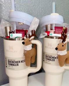 two coffee mugs with reindeer decorations on them