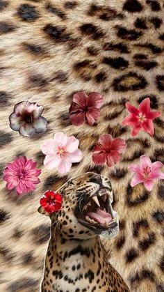 a leopard with its mouth open next to flowers