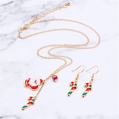 Celebrate the holiday season in style when you break out this festive set that's sure to satiate your sweet tooth. Includes drop earrings and pendant necklace (three pieces total) Earrings: 0.39'' W x 0.83'' L Chain: 15.75'' L with 1.97'' extender Pendant: 0.67'' W x 0.91'' L Lobster claw clasp 18k gold-plated / enamel Christmas Celebration Jewelry With Matching Earrings, Holiday Jewelry With Matching Earrings, Festive Christmas Jewelry With Matching Earrings, Christmas Jewelry Gift With Matching Earrings, Christmas Jewelry Gift Set With Matching Earrings, Christmas Jewelry Set As Gift With Matching Earrings, Holiday Dangle Jewelry With Matching Earrings, Festive Holiday Jewelry With Dangle Shape, Festive Holiday Dangle Jewelry