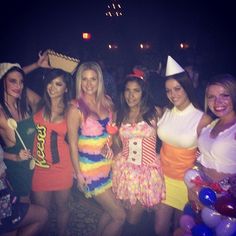 a group of women standing next to each other at a party