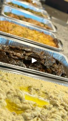 several trays filled with different types of food on top of a table next to each other