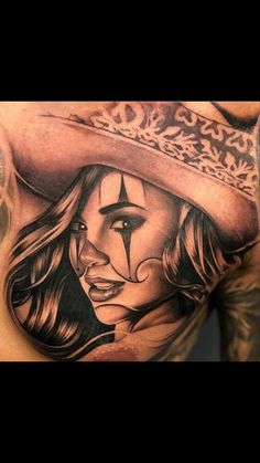 a man with a tattoo on his chest wearing a hat