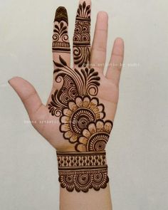 the hand is decorated with henna designs