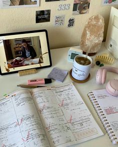 an open book sitting on top of a desk next to a computer