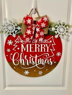 a red and white christmas ornament hanging on a door with snowflakes