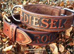 two leather belts with the words diesel rock on them sitting in some autumn leaves,