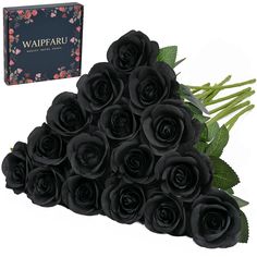 a bunch of black roses sitting next to a box