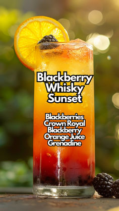 the blackberry whiskey sunset cocktail is garnished with orange and blackberries