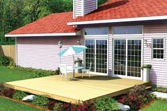 a house with a deck and an umbrella in the yard