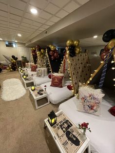 a room filled with lots of white tables and couches covered in gold foil balloons