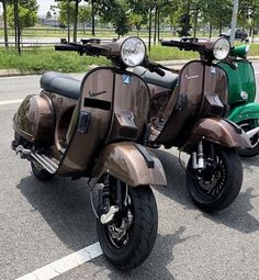 two mopeds parked next to each other in a parking lot