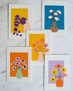 four cards with flowers in vases on them sitting on a marble counter top next to each other